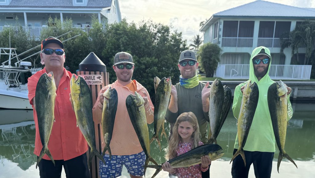 Happy Families fishing together at 711 8 Street Key Colony Beach, Florida. Waterfront villas with boat dock and pool. FloridaKeysVillas.com