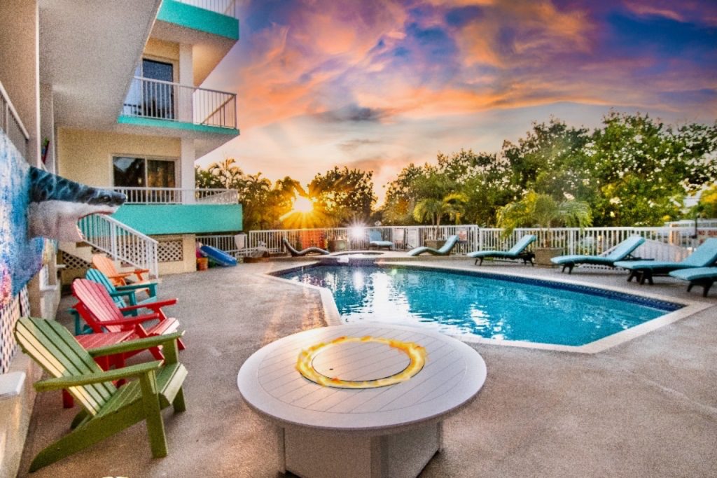 Outdoor pool and fire pit at sunset. 619 Sombrero Beach Rd., Marathon FL FloridaKeysVillas.com