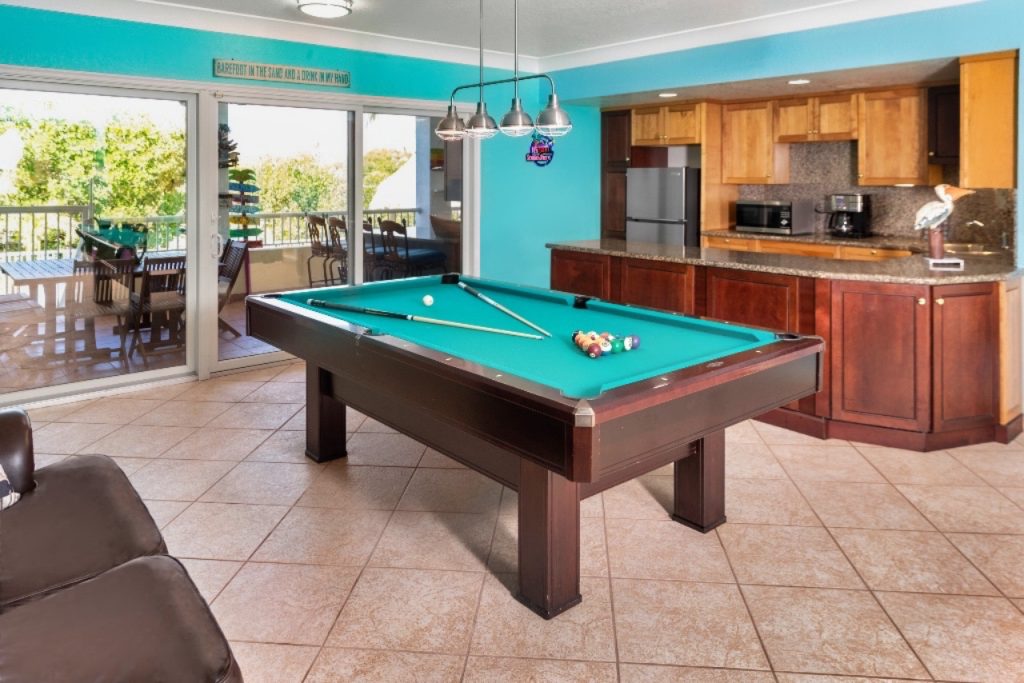 Pool table and family room with foosball table and TV room in 619 Sombrero Beach Rd, Florida Keys. FloridaKeysVillas.com