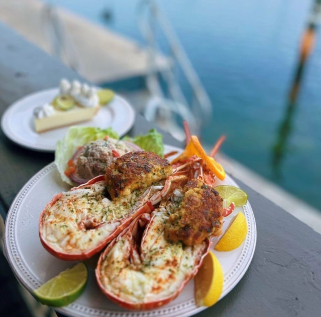 Split lobster tails topped with a baked or broiled herb–butter style topping with Crab cakes and Key Lime Pie