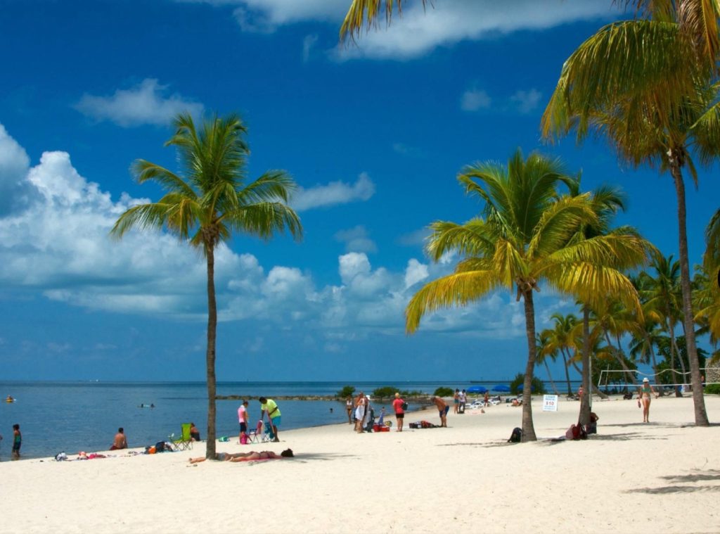 Smathers Beach Key West Florida palm trees and white sand shoreline. Smathers Beach in Key West Florida. FloridaKeysVillas.com