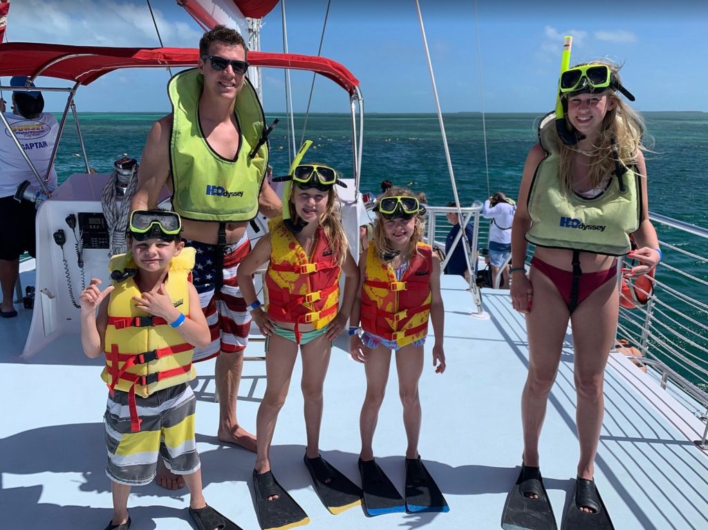 Family Going Snorkeling at the living coral reef of Sombrero Reef Marathon Florida. FloridaKeysVillas.com
