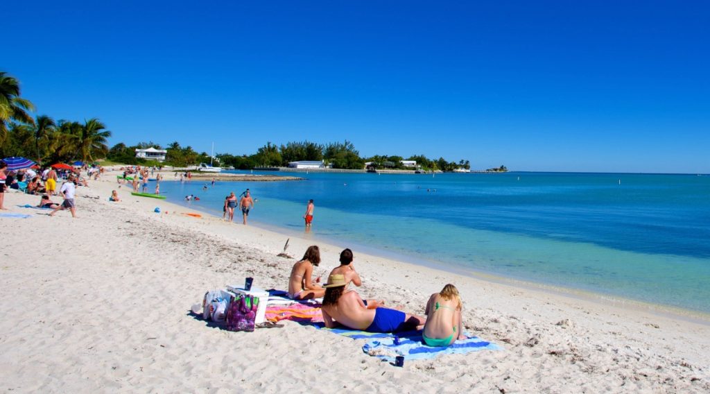 Family Sunbathing and picnic at Sombrero Beach. FloridaKeysVillas.com
