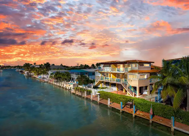 Waterfront homes in Key Colony Beach. Sunset dock view in Key Colony Beach. Book FloridaKeysVillas.com